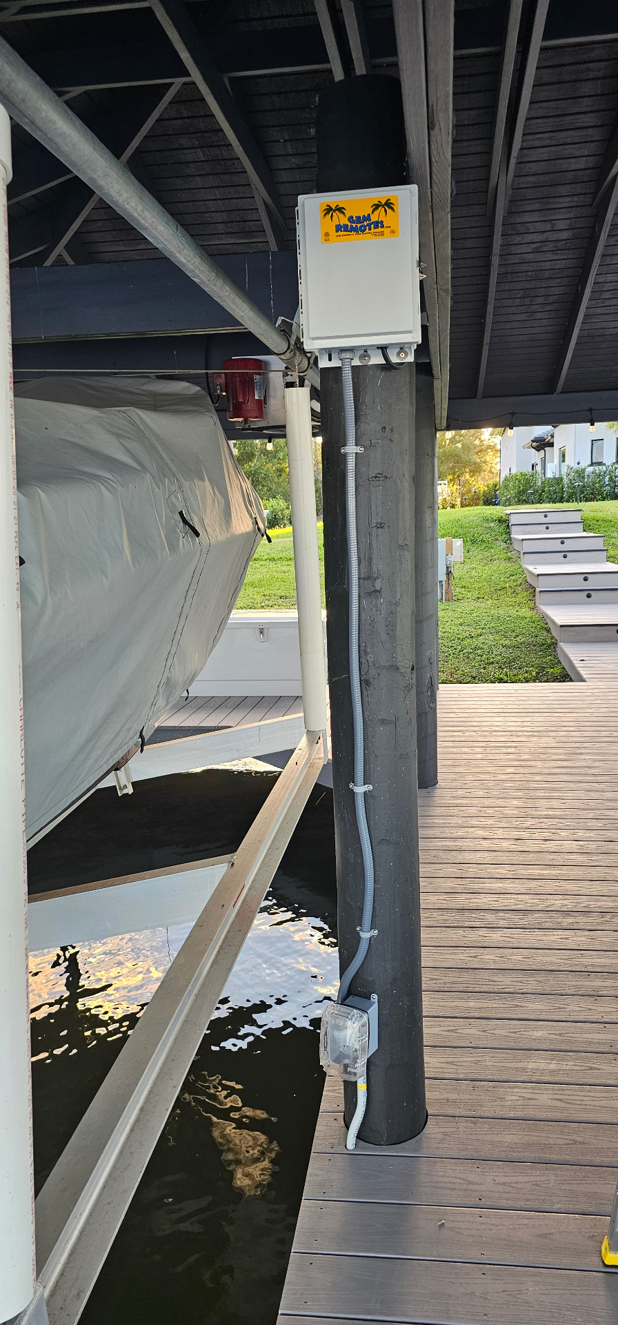 Dockside boat lift power equipment and weatherproof receptacle