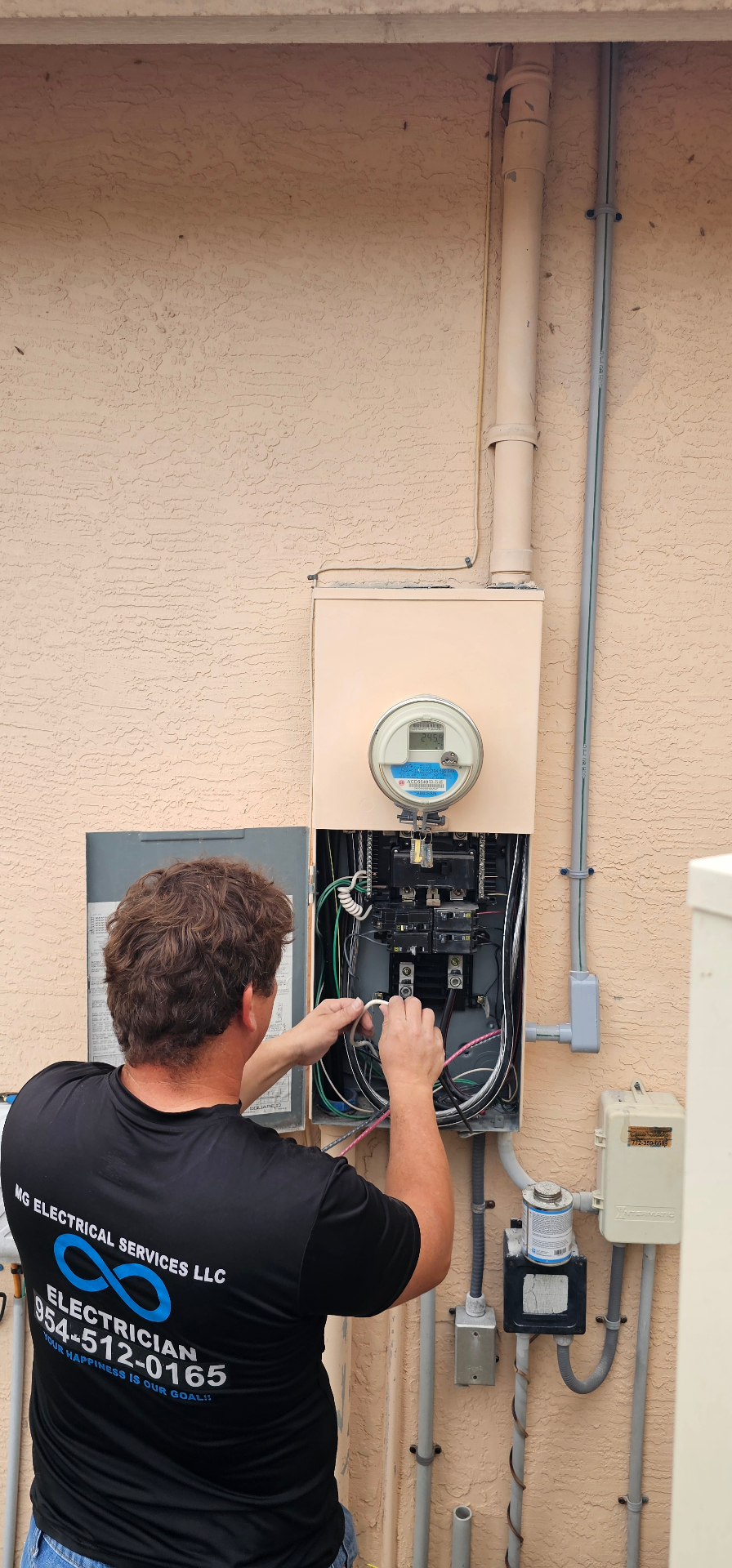 MG Electrical technician working on a residential meter and panel
